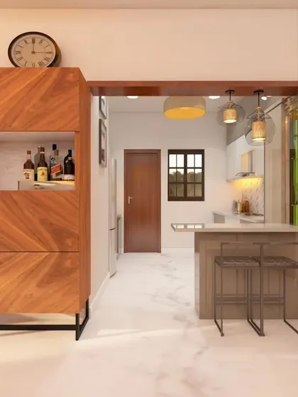 This design integrates a breakfast counter and a custom bar unit into the living space. The use of wood textures and strategic lighting creates a warm and functional area for casual dining and entertaining.