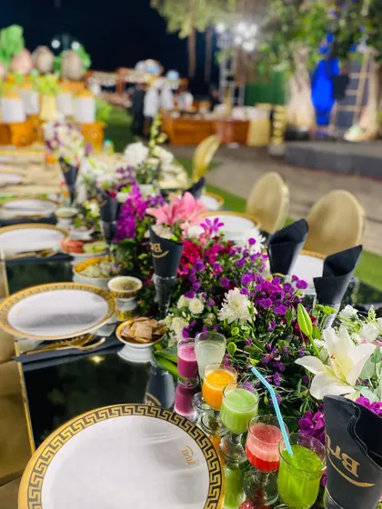 The vibrant array of juices adds a splash of color to the sophisticated table setting.