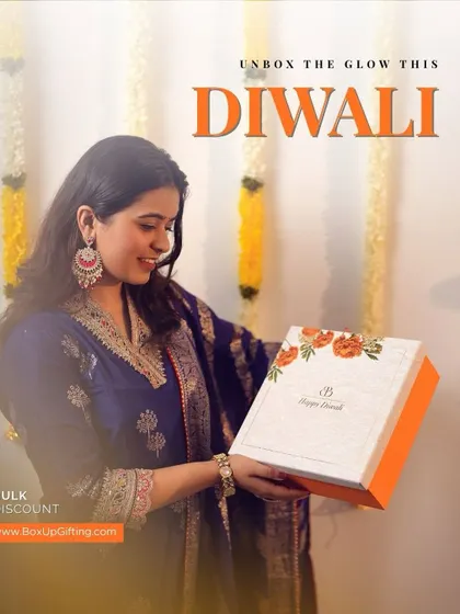 Our marigold-themed Diwali hamper is perfect for adding a touch of sunshine to the festival. A client holds the beautiful box, ready to "unbox the glow."