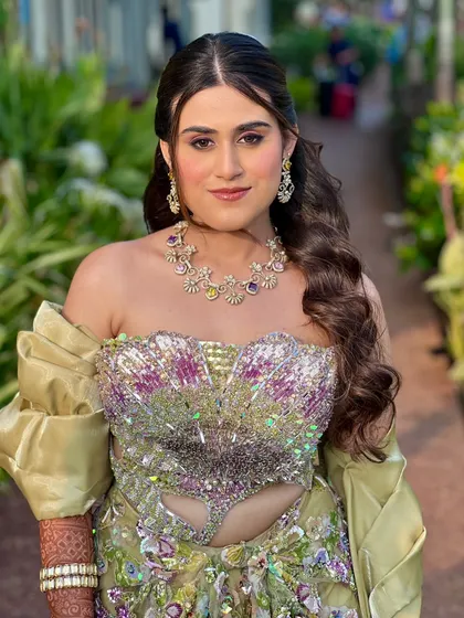 The full Mehendi look, perfect for a beachside celebration. The makeup is fresh and vibrant, complementing the colourful and modern outfit.