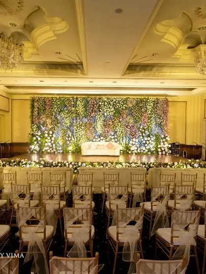 For this reception, we created a breathtaking backdrop with a wall of lavender and pastel florals. The strategic arrangement of hydrangeas, roses, and baby's breath created a magical and enchanting photo wall.