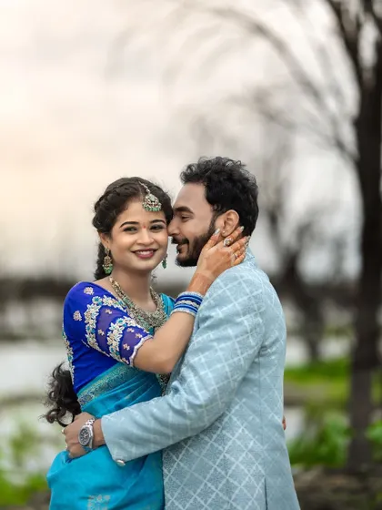 A sweet and intimate portrait of a couple during their engagement shoot by the lake. Their happy expressions are the focus of this beautiful shot.
