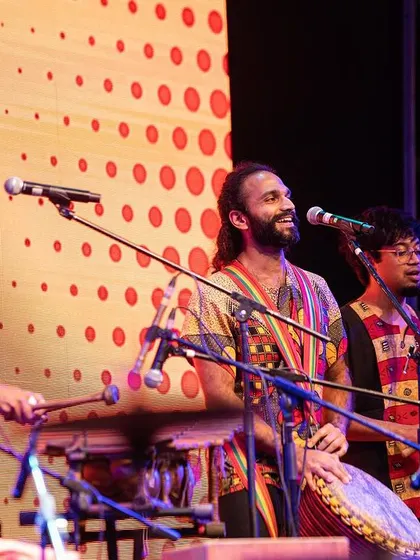 The full ensemble in action. We combine traditional West African instruments like the djembe and balafon with a modern drum kit to create a unique and powerful sound.