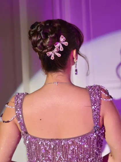A detailed shot of the braided bun, showcasing the intricate weaving and the placement of the beautiful, glittering butterfly accessories.