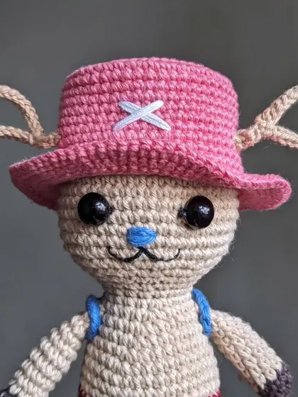 A close-up of the Chopper doll's face, highlighting his blue nose and friendly smile.