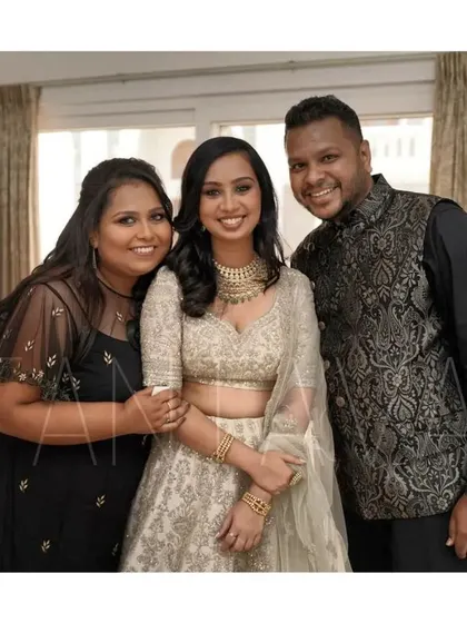 A happy client moment with the family. I designed the hand-embroidered black net cape gown for the sister of the bride, seen here with her proud family.