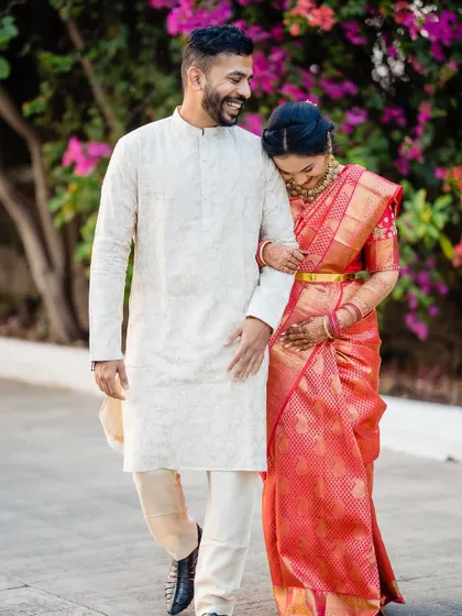 A candid shot of Devika and Laukik walking together, filled with laughter and joy.