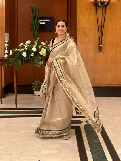 A full-length view of my sister's wedding guest look. The off-white saree paired with a contrasting black blouse creates a sophisticated and modern aesthetic.