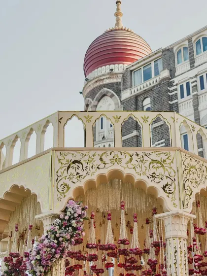 The iconic dome of the Taj Mahal Palace in Mumbai, framing a magnificent mandap. We are experts at integrating stunning architectural landmarks into our wedding designs.