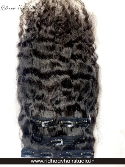 Our 4-piece premium curly clip-in hair extension set. These extensions add instant bouncy curls and volume, perfect for a glamorous look without any heat or damage.