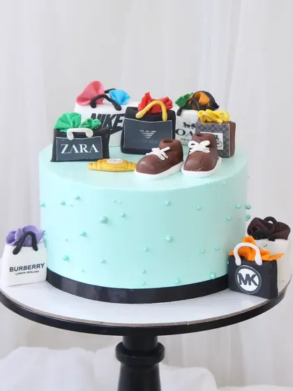 For the man who loves to shop in style. This cake is topped with an array of handcrafted, edible shopping bags from high-end brands like Zara, Nike, Burberry, and Michael Kors.