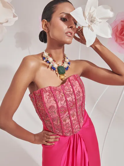 A pink corset-style top paired with a statement necklace. This highlights my skill in mixing bold jewellery with contemporary outfits.