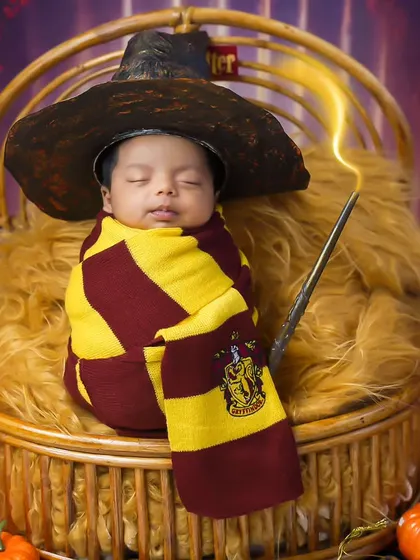 Our littlest wizard. This Harry Potter themed newborn shoot is pure magic, complete with a sorting hat, wand, and Gryffindor scarf.