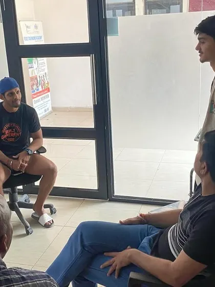 A coach sits down with parents and an athlete for a discussion. We maintain open communication and believe that parental involvement is crucial for a young athlete's growth and motivation.