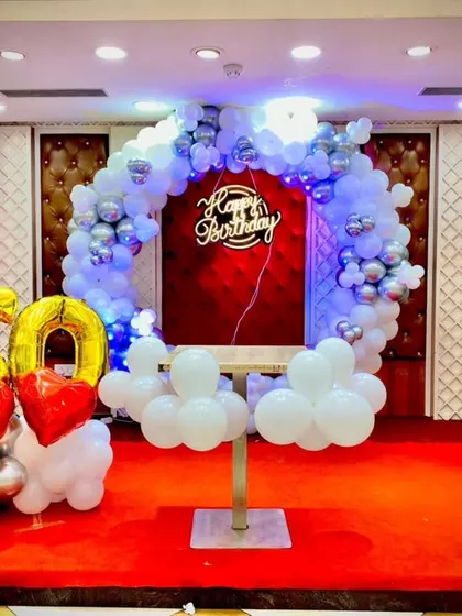 A wide shot of the 60th birthday stage, showing the scale of the decoration in a banquet hall setting.