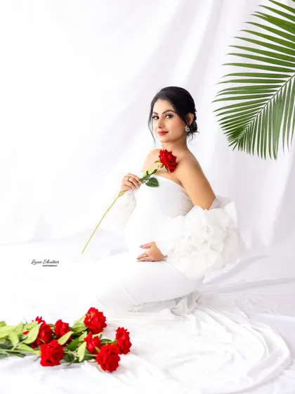 Simple can be absolutely stunning. This classic white gown with ruffled sleeves, paired with a single red rose, creates a look of pure elegance and romance against a clean, bright backdrop.