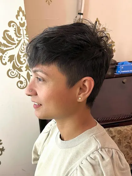 The side view showcases the clean undercut and the soft texture on top.