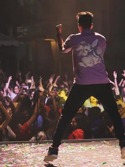 A duplicate of 60, this action shot shows me jumping on stage, matching the high energy of the college fest crowd.