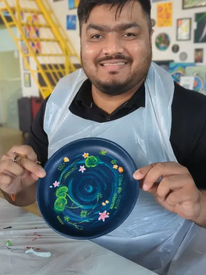 A proud team member showing off the finished resin koi pond he created during a corporate workshop. Everyone gets to take home a unique piece of art.