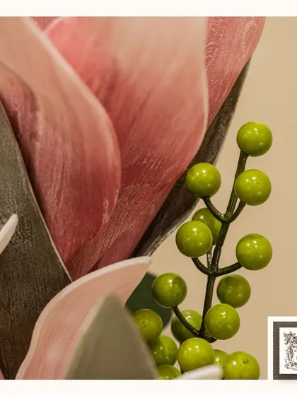 A close-up of the delicate pink petals and green berries in a luxurious floral arrangement, showcasing the high-quality materials I use.