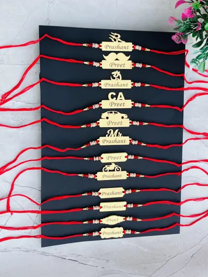 A collection of my custom name rakhis with various symbols like Om, a car, a mustache, and a motorcycle, allowing you to match the rakhi to your brother's personality.