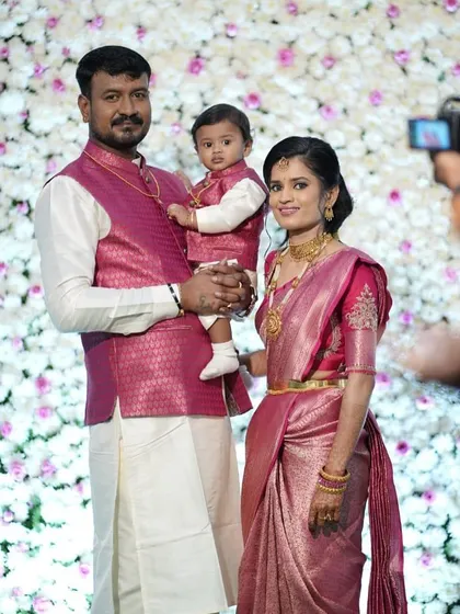 A picture-perfect family. We designed a pink Kanjivaram saree and blouse for the mother, and a matching brocade jacket for her husband and son.