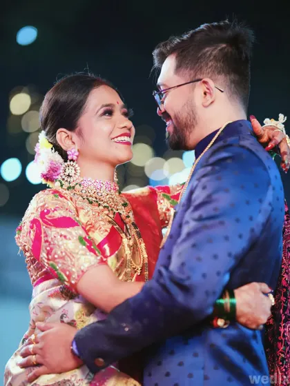 A happy, candid shot of a couple dancing at their reception, surrounded by beautiful bokeh lights.