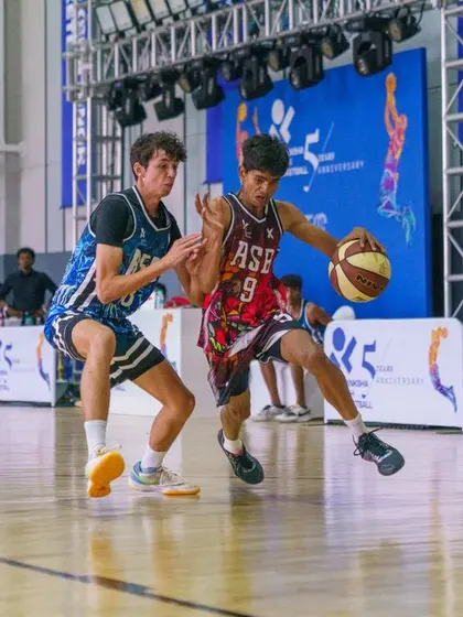 A young player drives past a defender, showing the skill and confidence we build from an early age.