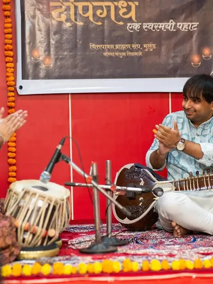 Applauding my accompanist after a brilliant tabla solo. Our performances are a partnership, and I always appreciate the artistry my fellow musicians bring to the stage.