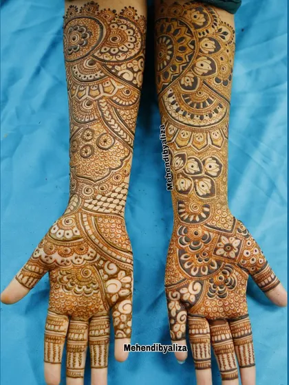 Full-arm geometrical henna art. This design is a mesmerizing collection of mandalas, dots, and lines that flow from the palm to the elbow.