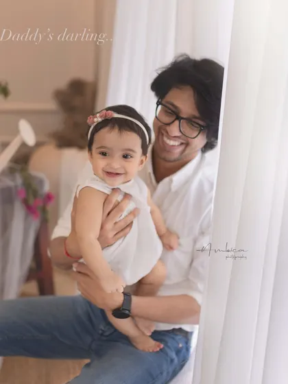 "Daddy's darling." The pure joy shared between a father and his baby girl. His infectious smile and her happy expression make this a truly heartwarming portrait.