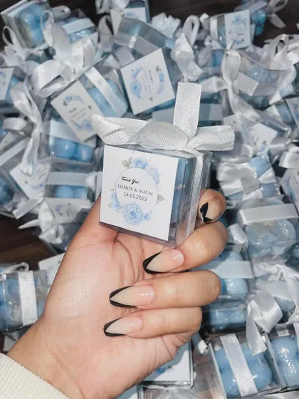 These baby blue bubble candles were created as wedding favors, each with a custom floral tag and white ribbon.
