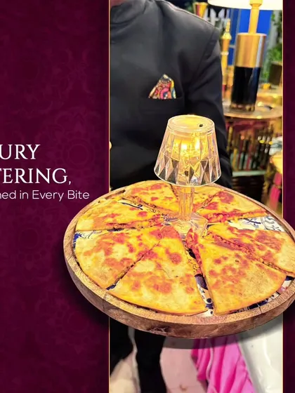 Luxury catering, redefined in every bite. A server presents a unique pizza-quesadilla hybrid, showcasing our creative approach to familiar dishes.