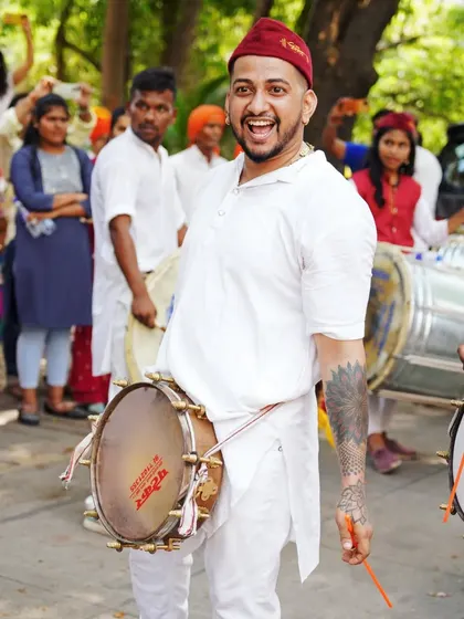 A candid portrait of a drummer, his face lit up with a huge smile. Capturing these genuine moments of happiness is what makes festival photography so rewarding.