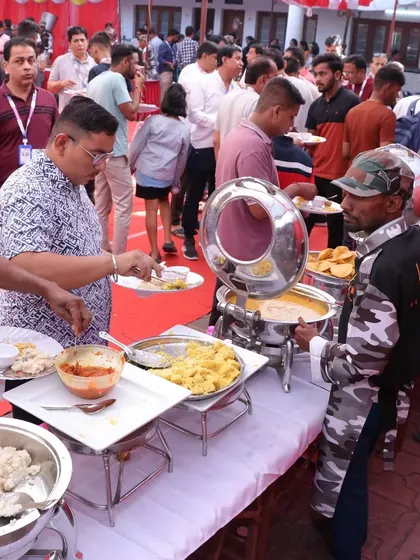 A bustling buffet line at a corporate event. Our staff is trained to manage large crowds efficiently, keeping the line moving and the food fresh.