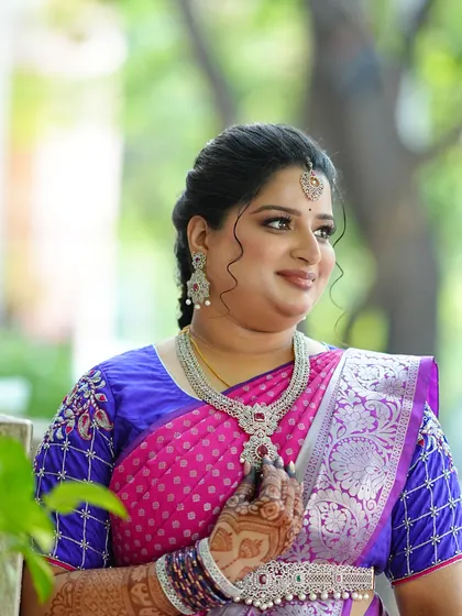 A beautiful, gracious look for an engagement ceremony. The makeup features soft, shimmery eyes and a natural lip color, paired with stunning diamond jewellery and a vibrant pink and blue saree.