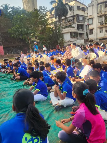 A large group of our students sits attentively during a session at our sports camp. We believe in educating our athletes on all aspects of sports, including performance and safety.