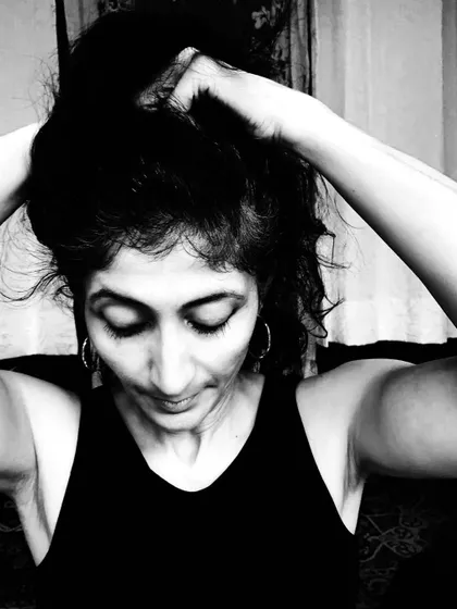 A black and white portrait capturing a moment of introspection. The contrast of tones reflects the contrasts of life and the journey of an artist.