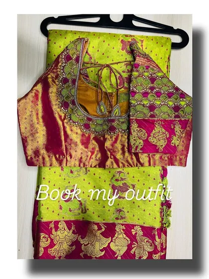 This bridal blouse combines multiple embroidery techniques, including threadwork, zari, and stone embellishments around the neckline. The intricate pattern and vibrant colors make it a standout piece for any wedding ceremony.