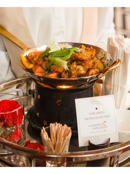 A tray of Stir-Fried Mongolian Fish, served warm in a personal chafing dish, ensuring the appetizer stays hot and flavourful.