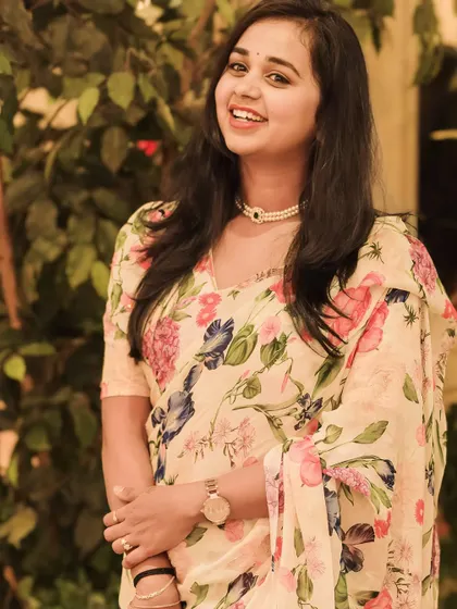 A client looking elegant in a floral print saree, a perfect example of carrying a designer outfit with grace.