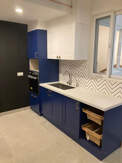 Dream kitchen unlocked. Now to learn how to actually cook something edible. A bold blue and white kitchen with a fun chevron-patterned backsplash.