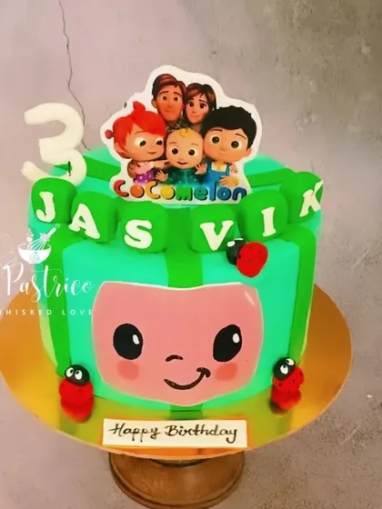A fun, square-shaped Cocomelon cake with edible prints and cute ladybug details for a 3rd birthday.