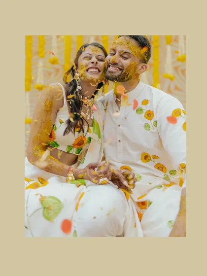 A joyful, turmeric-covered kiss between Avin and Nikki. This close-up captures the fun and intimacy of the Haldi ceremony perfectly.