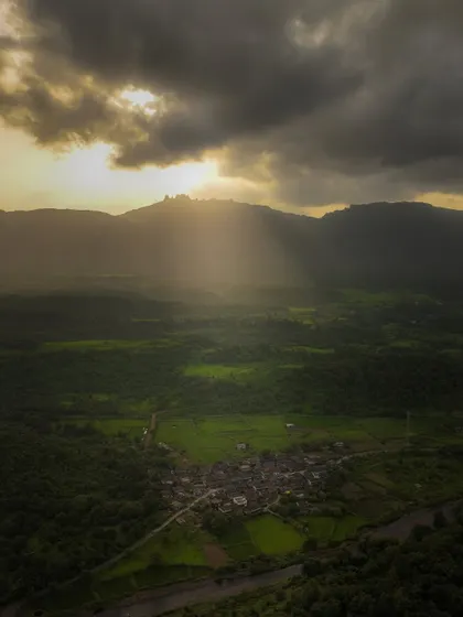 The sun's rays break through the clouds over the village of Chinchavali. These divine light beams are a magical moment that only lasts for a few seconds, and I was lucky to capture it.