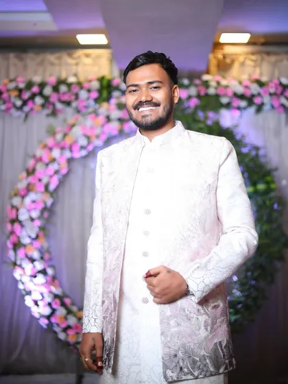 A joyful portrait of the groom, smiling brightly at his engagement. The happiness of the moment is perfectly captured in his expression.