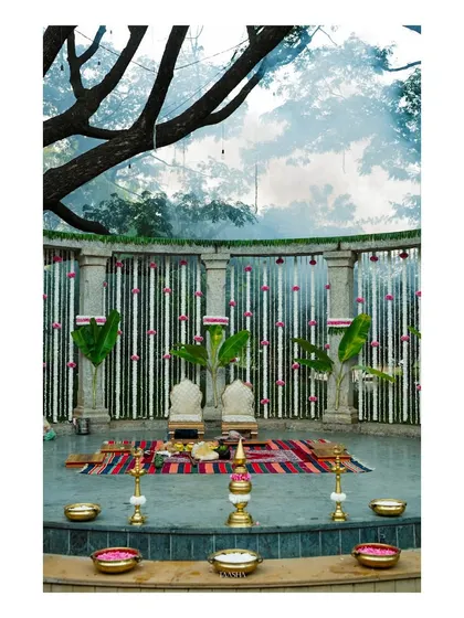The mandap is a tapestry of tradition, with tuberose and nerium flowers, banana leaves, and brass urlis filled with petals. Every detail is thoughtfully placed to reflect heritage and grace.