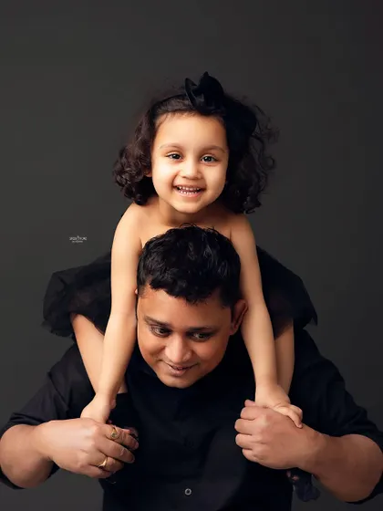 Piggyback rides from dad are the best! This fun and energetic shot perfectly captures the playful relationship between a father and his daughter.