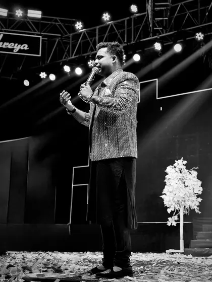 A black and white shot that captures the drama and emotion of a live performance. Even without color, you can feel the energy and passion I bring to my hosting.