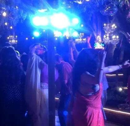 The dance floor is washed in blue light.